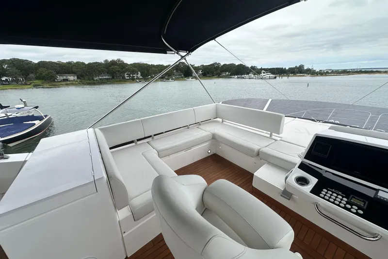 Slide: The Image of Luxurious 2018 Sunseeker Manhattan 52 yacht interior with white seating and control panel. - 78