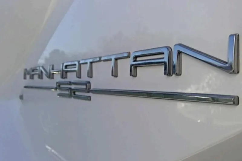 Slide: The Image of Close-up of 2018 Sunseeker Manhattan 52 yacht emblem on white surface. - 8