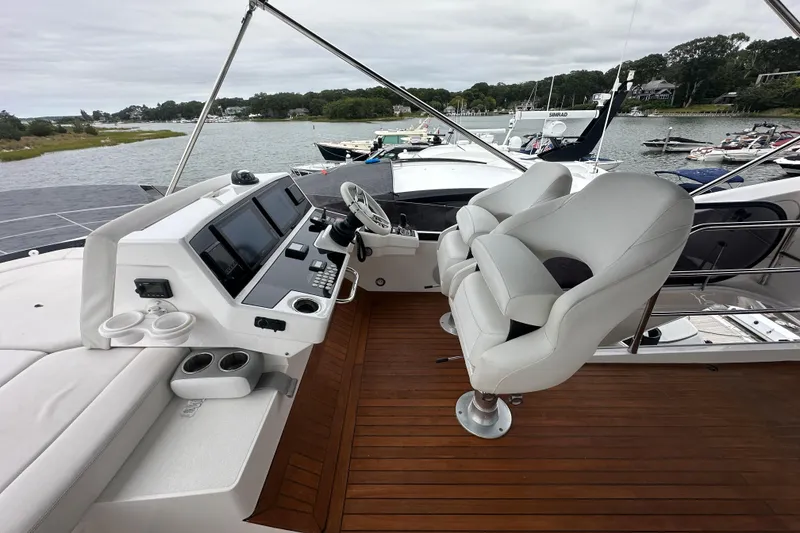 Slide: The Image of Luxurious 2018 Sunseeker Manhattan 52 yacht helm with modern controls and plush seating. - 80