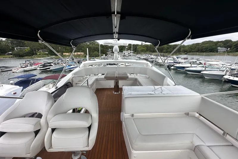 Slide: The Image of 2018 Sunseeker Manhattan 52 yacht interior with seating, docked at marina. - 81