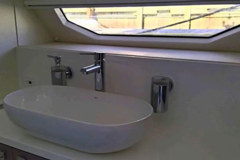Slide: The Image of Modern bathroom sink in 2018 Sunseeker Manhattan 52 yacht, featuring sleek design and window view. - 86