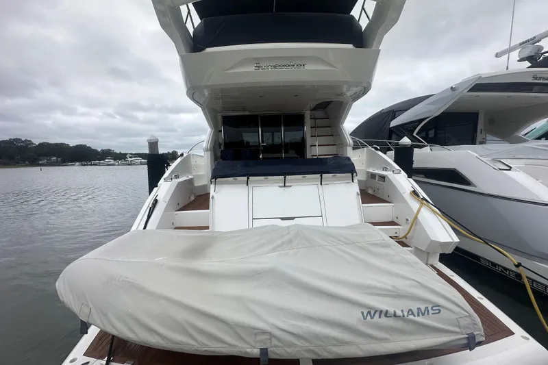 Slide: The Image of 2018 Sunseeker Manhattan 52 yacht docked, rear view with covered tender. - 9