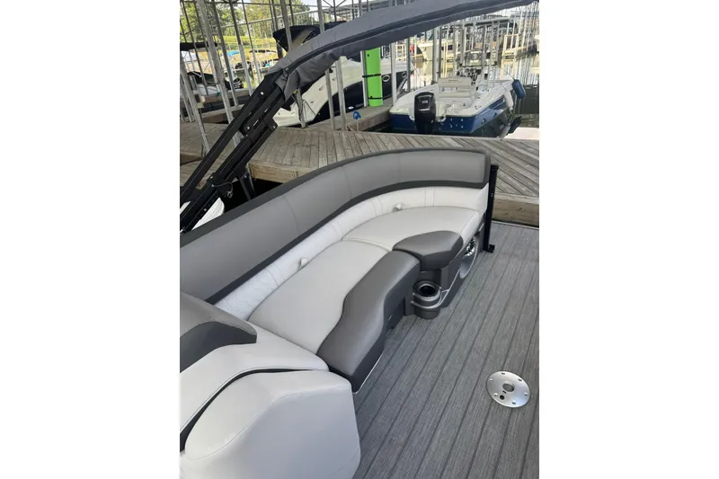 Slide: The Image of 2021 Avalon LSZ Entertainer 24' pontoon boat with gray seating and cup holders. - 9