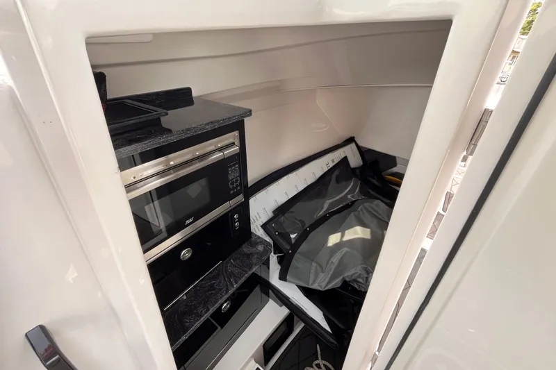 Slide: The Image of Interior of 2025 Fountain 39 DX boat with microwave and storage area. - 24