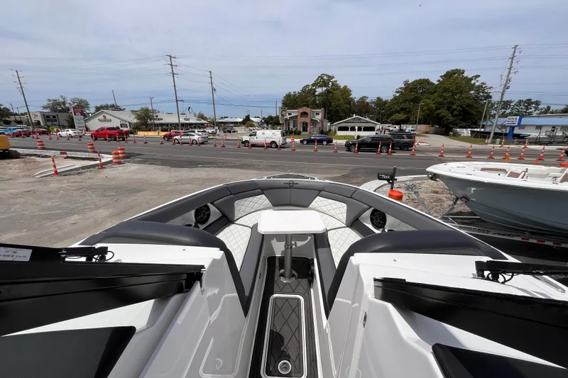 Slide: The Image of 2025 Fountain 39 DX boat interior with modern seating, parked near a busy street. - 27
