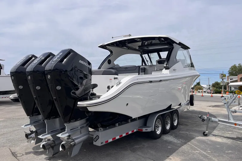 Slide: The Image of 2025 Fountain 39 DX boat with triple Mercury engines on a trailer. - 5