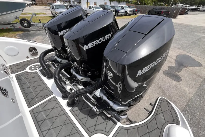 Slide: The Image of Triple Mercury outboard engines on a 2025 Fountain 39 DX boat, dockside view. - 7