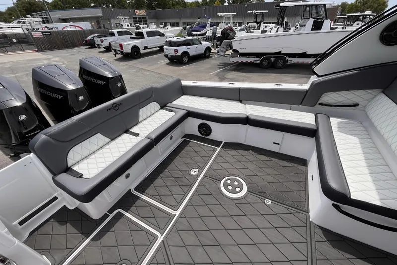 Slide: The Image of 2025 Fountain 39 DX boat interior with luxurious seating and Mercury engines in a marina setting. - 9