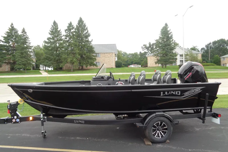 The Image of 2026 Lund 1800 Explorer SS boat on trailer, parked in suburban neighborhood. - 1