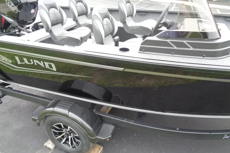 Slide: The Image of 2026 Lund 1800 Explorer SS boat with sleek black exterior and modern seating. - 10