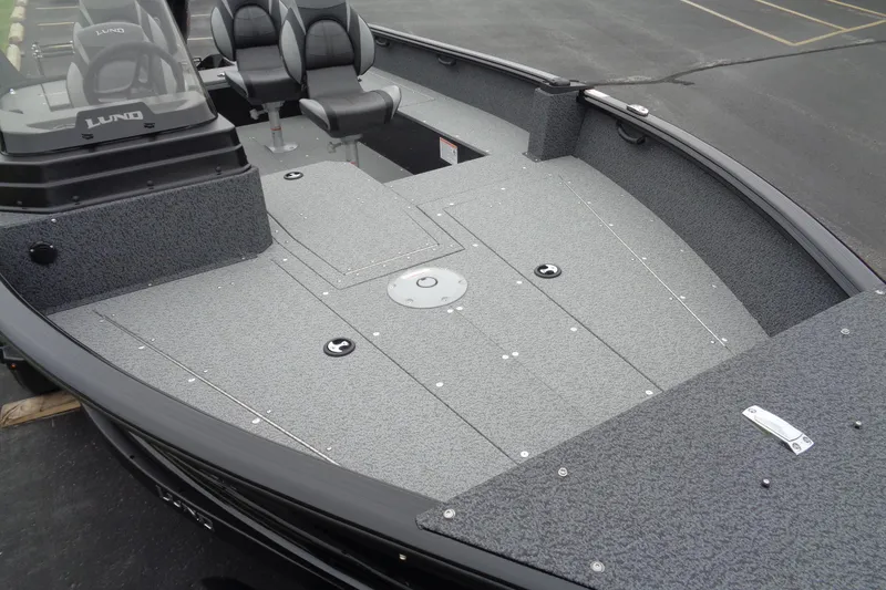 Slide: The Image of 2026 Lund 1800 Explorer SS boat interior with seating and storage compartments. - 11