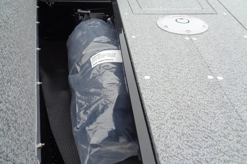 Slide: The Image of 2026 Lund 1800 Explorer SS boat storage compartment with packaged item inside. - 12