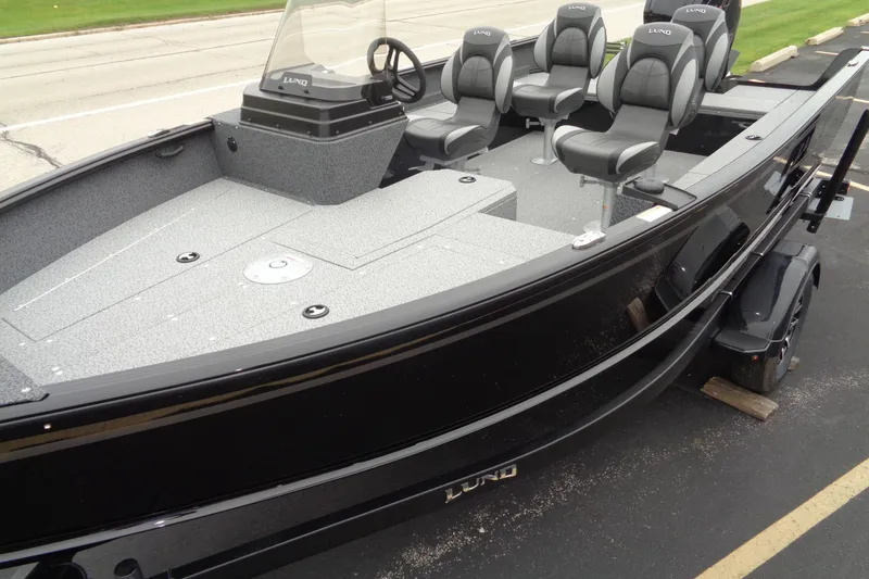 Slide: The Image of 2026 Lund 1800 Explorer SS boat with sleek black exterior and comfortable seating. - 13