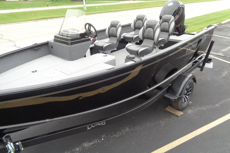 Slide: The Image of 2026 Lund 1800 Explorer SS boat with sleek black design and modern seating. - 4