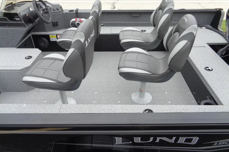 Slide: The Image of 2026 Lund 1800 Explorer SS boat interior with four gray seats and steering console. - 6