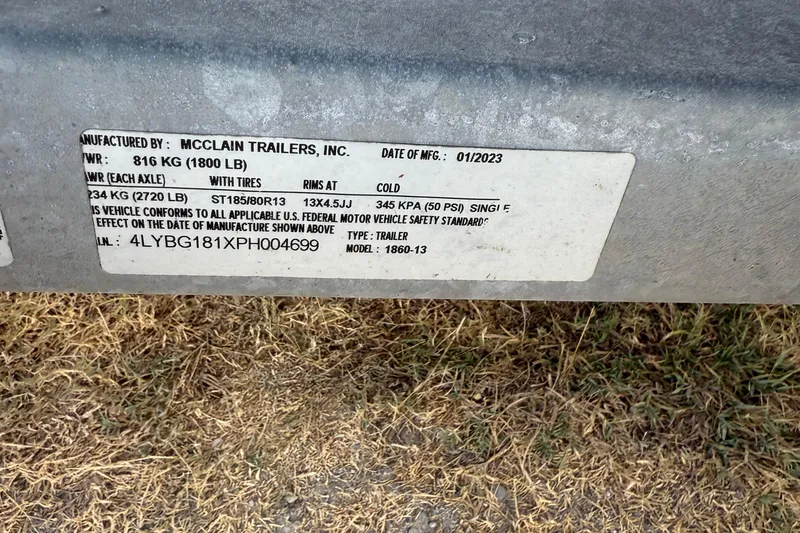Slide: The Image of Label on McClain trailer, manufactured 01/2023, showing weight and tire specifications. - 19