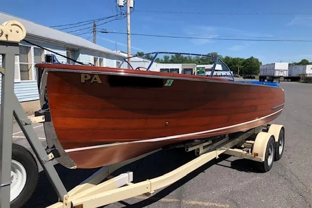 The Image of 1946 Chris-Craft U-22 Sportsman wooden boat on trailer, parked outdoors. - 0