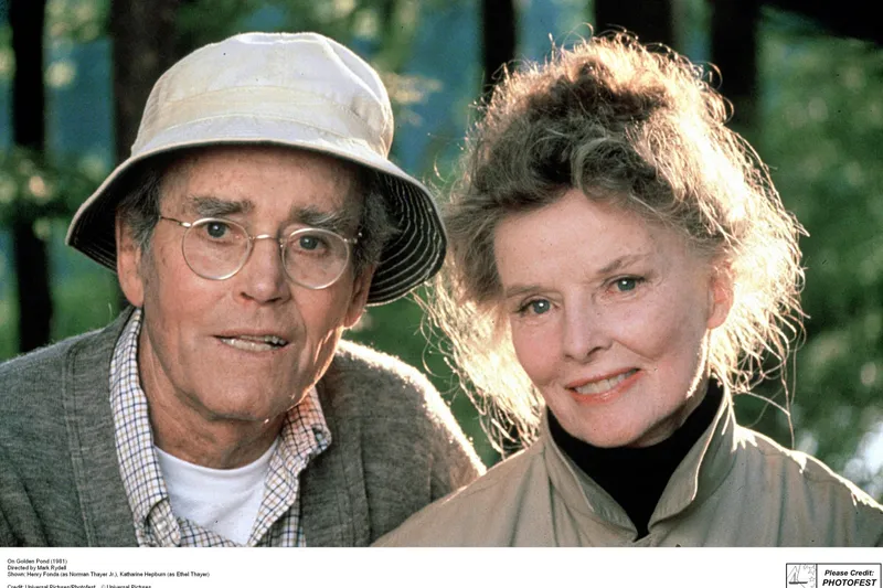 Slide: The Image of Elderly couple smiling outdoors, wearing casual attire, surrounded by trees. - 18