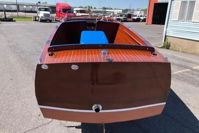 Slide: The Image of 1946 Chris-Craft U-22 Sportsman boat with polished wood finish, parked outdoors. - 2