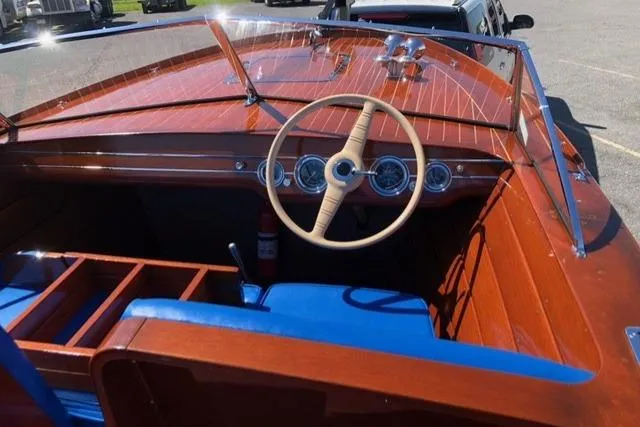 Slide: The Image of 1946 Chris-Craft U-22 Sportsman boat interior with wooden dashboard and blue seating. - 3