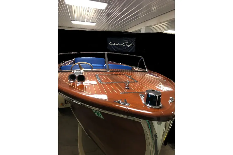 Slide: The Image of 1946 Chris-Craft U-22 Sportsman boat with polished wood finish and blue interior. - 4
