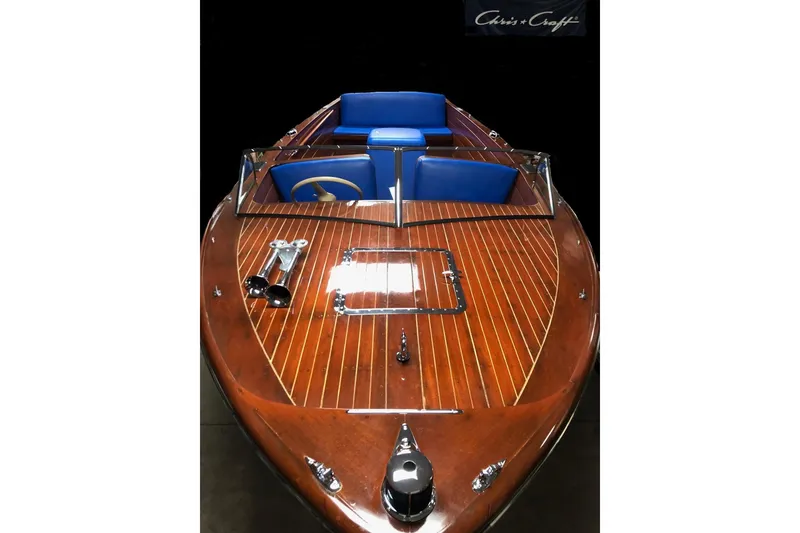 Slide: The Image of 1946 Chris-Craft U-22 Sportsman boat with polished wood finish and blue seating. - 5