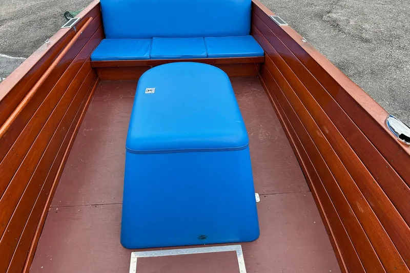 Slide: The Image of 1946 Chris-Craft U-22 Sportsman boat interior with blue seating and wooden panels. - 7
