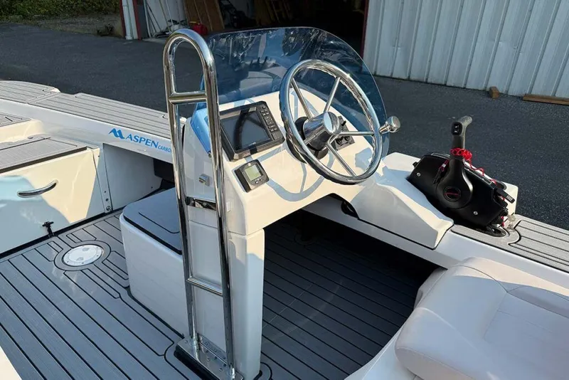 Slide: The Image of Aspen Carbon Cat T13C 2026 on trailer outdoors. - 2