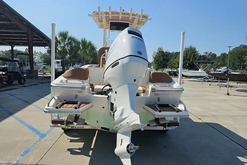 Slide: The Image of 2026 Pioneer 202 Islander boat with powerful outboard motor in a sunny marina setting. - 10