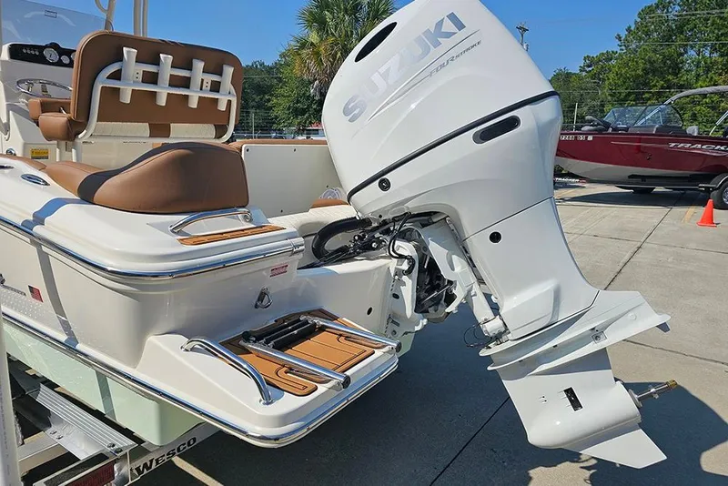 Slide: The Image of 2026 Pioneer 202 Islander boat with Suzuki outboard motor, featuring brown seating and swim platform. - 11