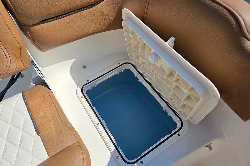 Slide: The Image of Open storage compartment on 2026 Pioneer 202 Islander boat with brown seating. - 13