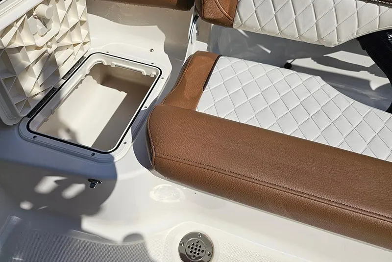Slide: The Image of 2026 Pioneer 202 Islander boat interior with brown and white seating and open storage compartment. - 14