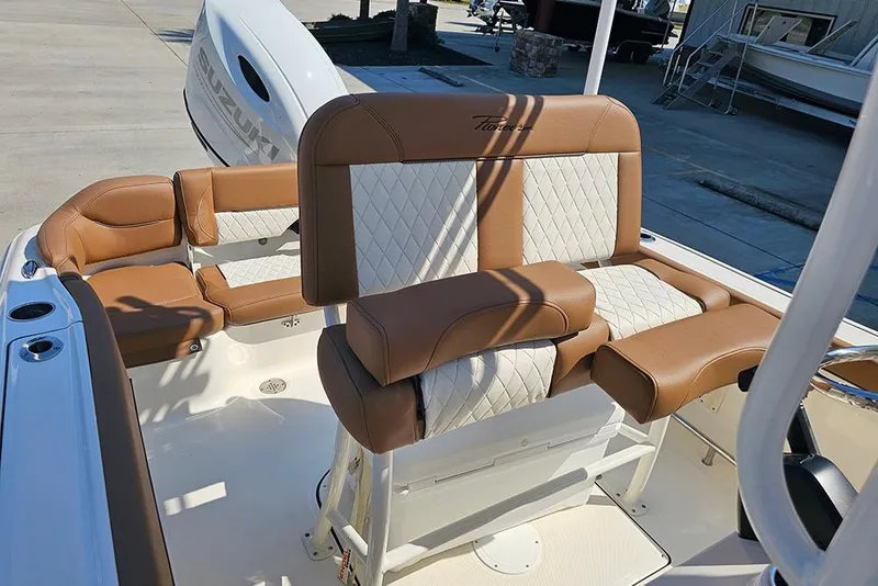 Slide: The Image of 2026 Pioneer 202 Islander boat interior with tan and white cushioned seating. - 15