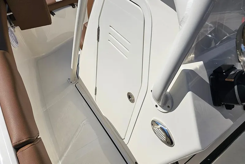 Slide: The Image of 2026 Pioneer 202 Islander boat interior with white console and brown seating. - 16
