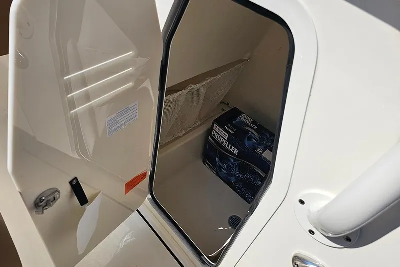 Slide: The Image of Open storage compartment on 2026 Pioneer 202 Islander boat with propeller box inside. - 17