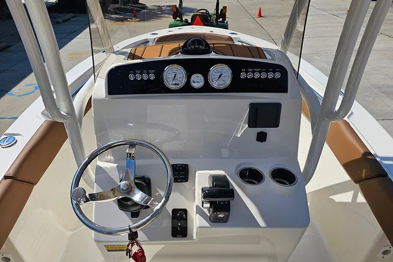 Slide: The Image of 2026 Pioneer 202 Islander boat dashboard with steering wheel and control panel. - 18