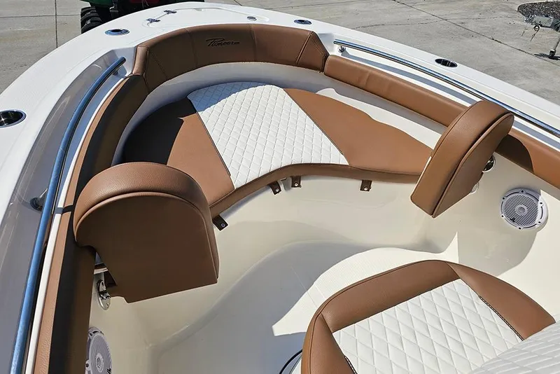 Slide: The Image of 2026 Pioneer 202 Islander boat interior with brown and white cushioned seating. - 21