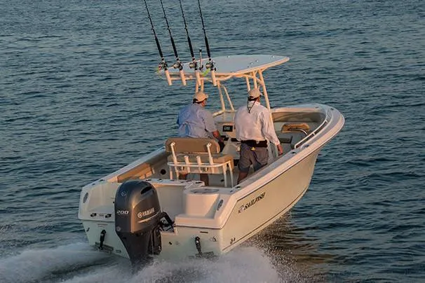 Slide: The Image of Manufacturer Provided Image: 2022 Sailfish 220 CC boat cruising on water with two people onboard. - 2