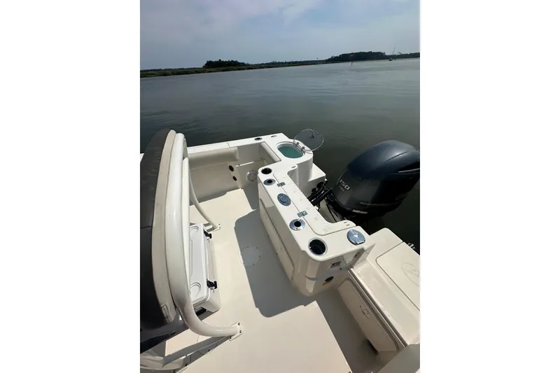 Slide: The Image of 2022 Sailfish 220 CC boat interior with outboard motor on calm water. - 20