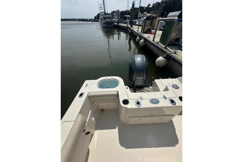 Slide: The Image of 2022 Sailfish 220 CC boat docked, featuring a 150 horsepower engine. - 22