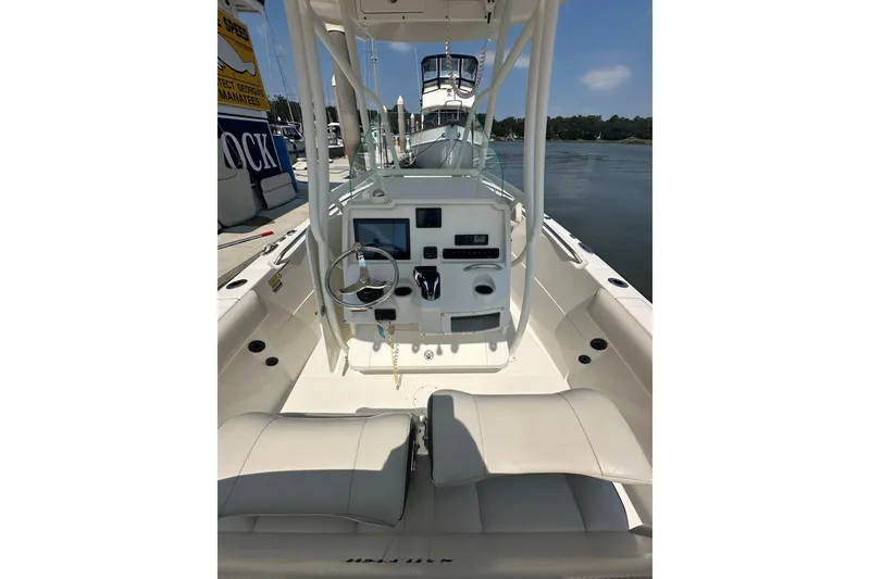 Slide: The Image of 2022 Sailfish 220 CC boat interior with steering wheel and control panel. - 23