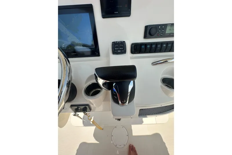 Slide: The Image of 2022 Sailfish 220 CC boat dashboard with controls and navigation screen. - 25