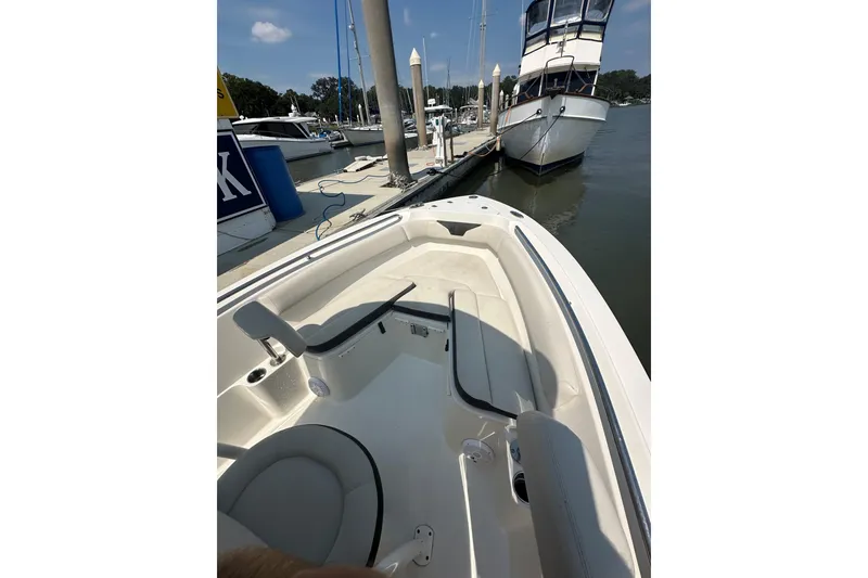 Slide: The Image of 2022 Sailfish 220 CC boat docked at marina, interior view. - 29