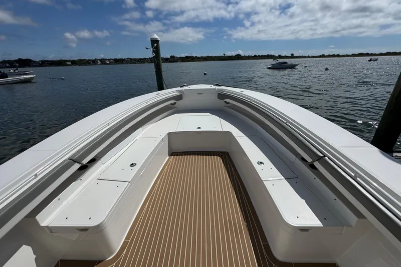 Slide: The Image of 2023 Regulator 34 Center Console boat on calm water, featuring spacious seating and sleek design. - 16