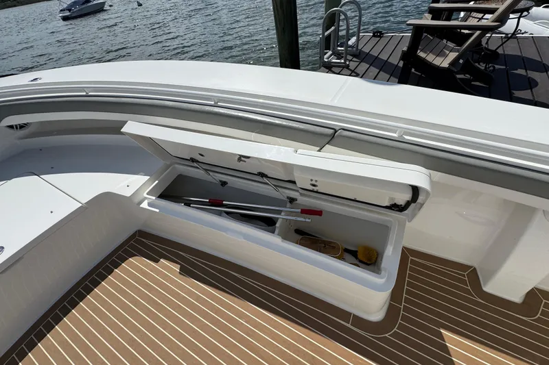 Slide: The Image of 2023 Regulator 34 Center Console boat with open storage compartment on deck. - 20