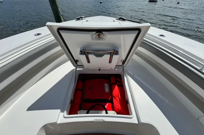 Slide: The Image of 2023 Regulator 34 Center Console boat with open storage compartment and life jackets. - 21