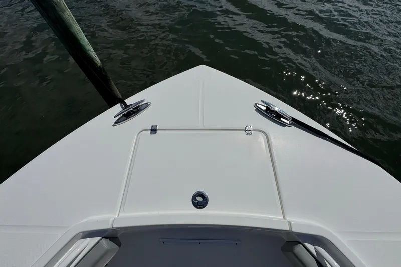 Slide: The Image of 2023 Regulator 34 Center Console boat bow on water, showcasing sleek design. - 22