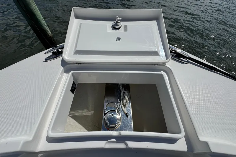 Slide: The Image of 2023 Regulator 34 Center Console anchor locker with open hatch, dockside view. - 23