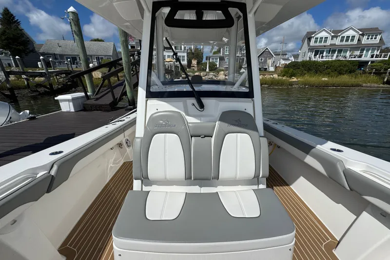 Slide: The Image of 2023 Regulator 34 Center Console boat interior with seating, dockside view. - 24