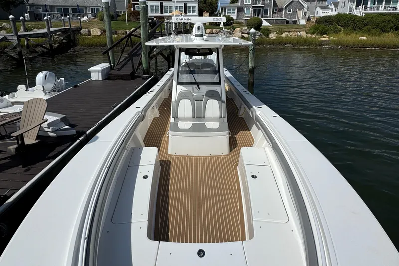 Slide: The Image of 2023 Regulator 34 Center Console boat docked, featuring spacious deck and modern design. - 28